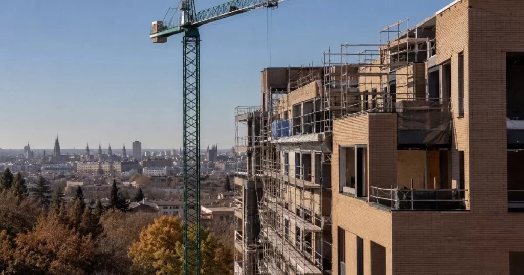 Obra de construccion de edificio residencial moderno en Zaragoza con gruas y skyline